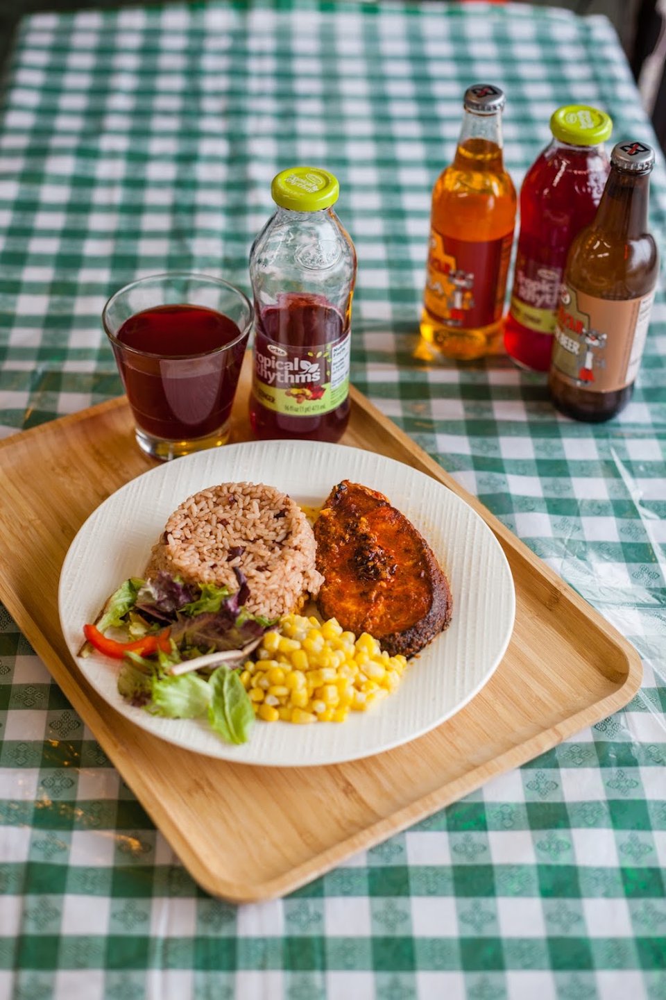 Restaurant menu with oxtail, curry goat, and drinks.