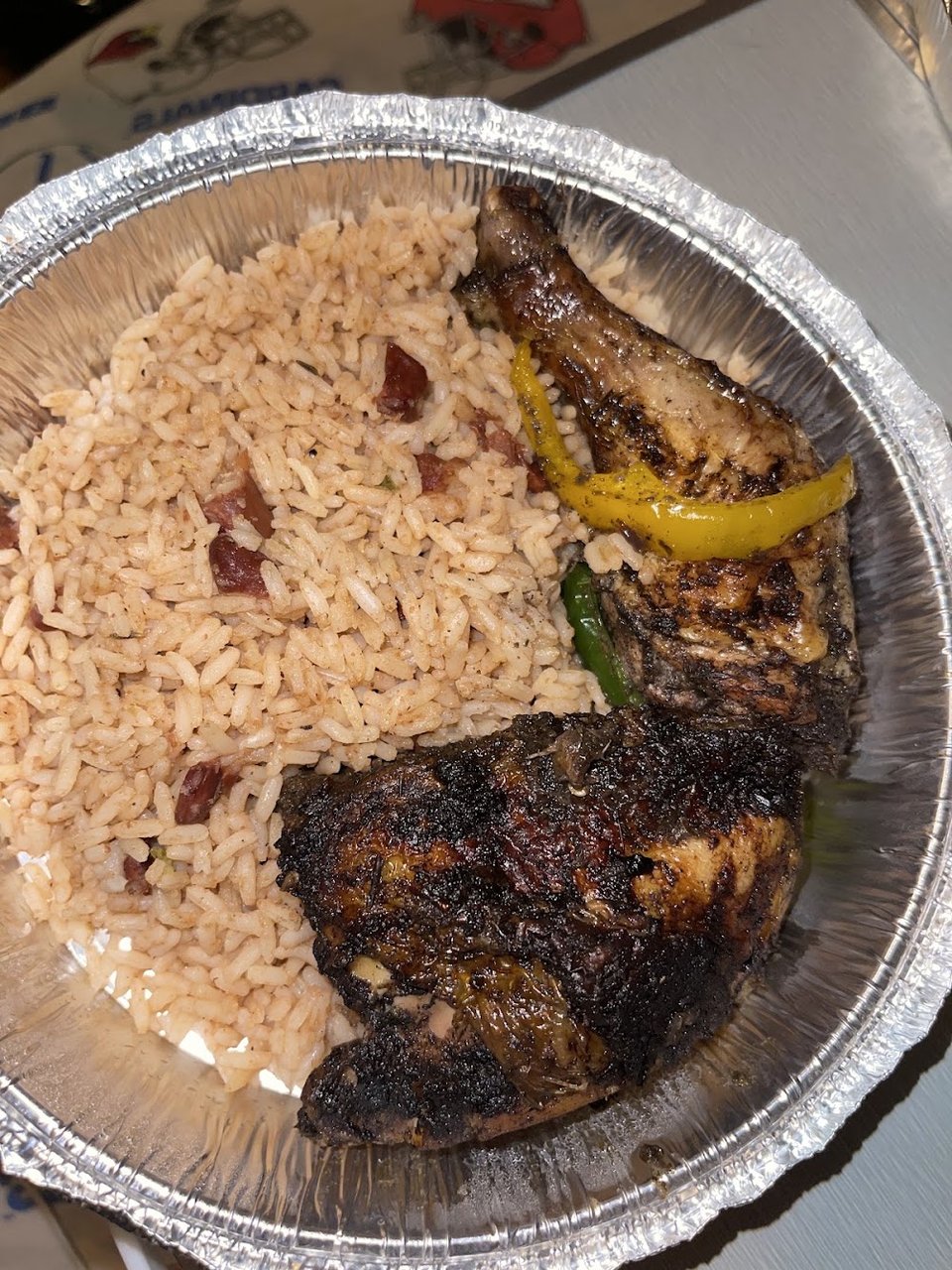 Restaurant menu with oxtail, curry goat, and drinks.